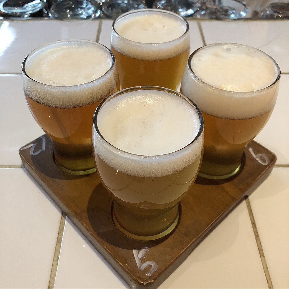 A flight of several craft beers on a tray