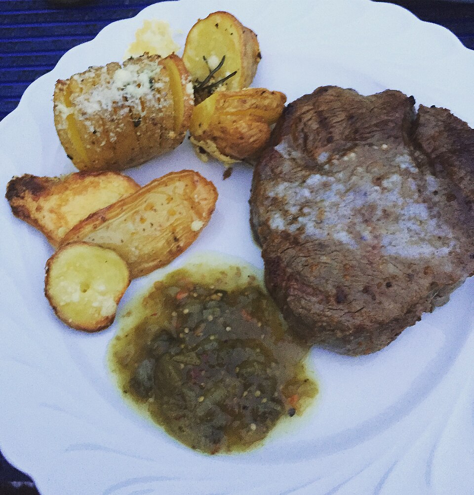 A thick grilled steak served on a plate