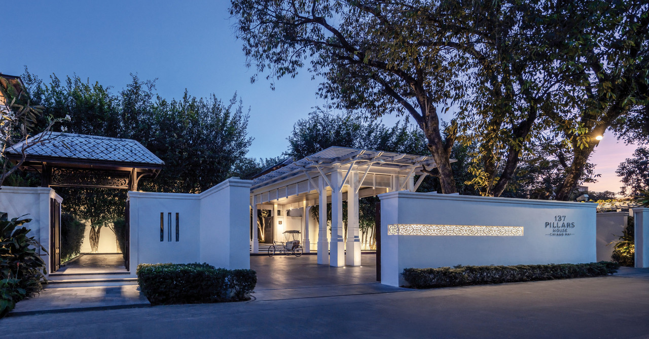 137 Pillars House entrance gate lit at dusk with hotel name signage