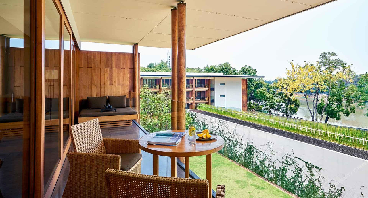 Balcony terrace with daybed and river garden views
