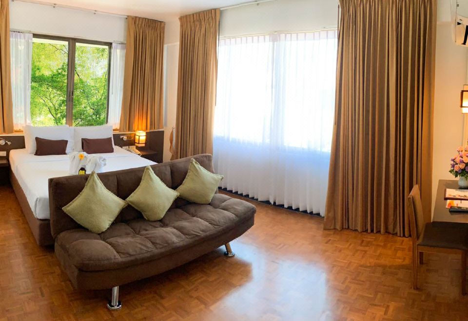 Hotel M Deluxe room with sofa and garden view