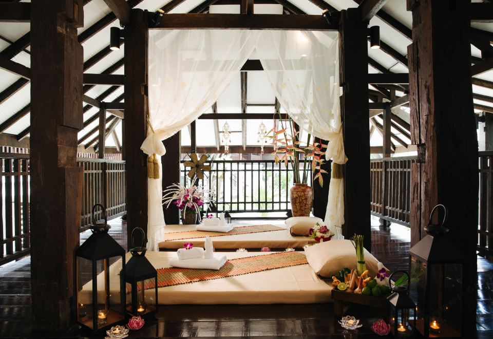 Traditional Lanna spa room with dark wood architecture