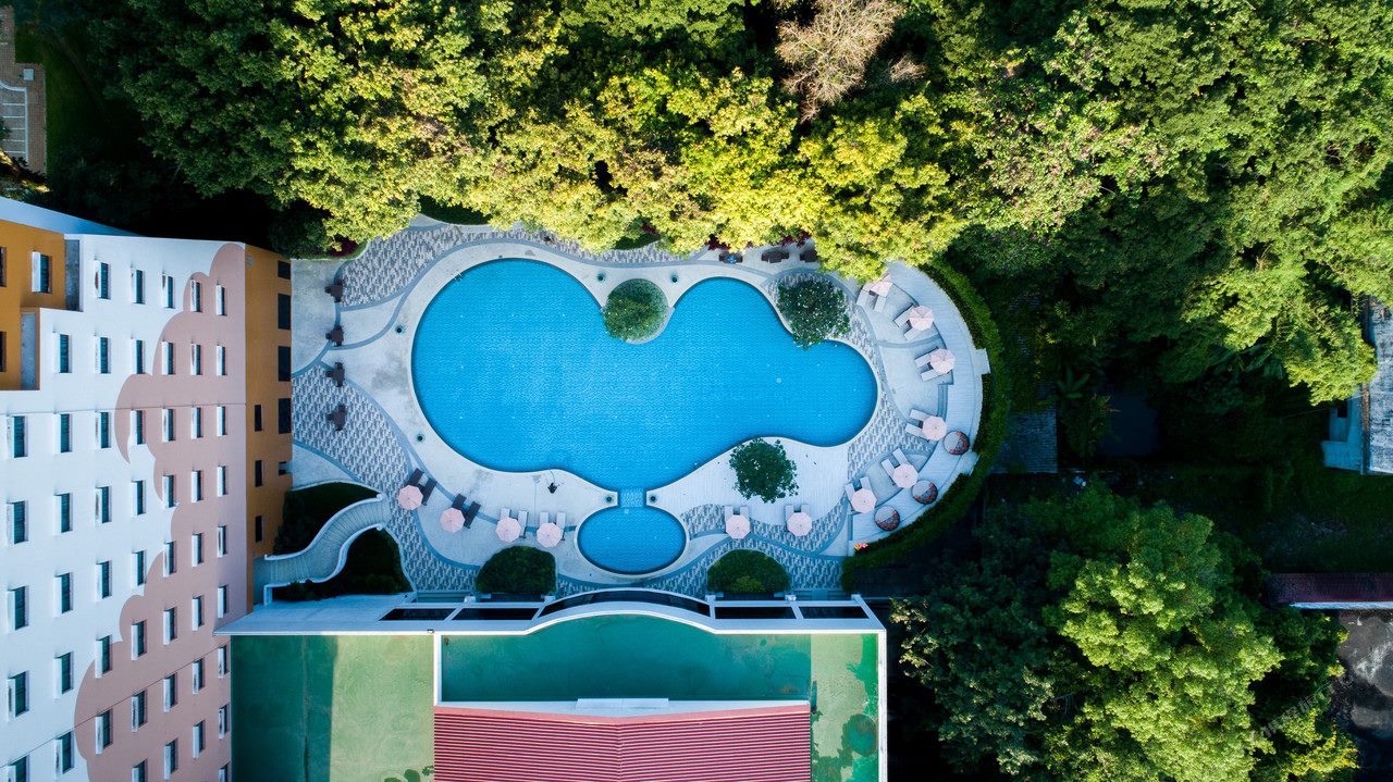Aerial view of the curved saltwater garden pool at The Heritage Chiang Rai