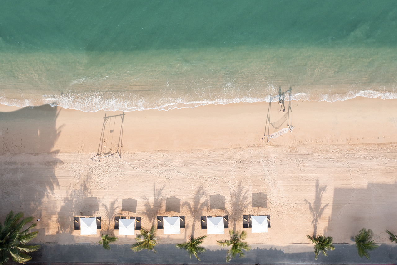 Aerial view of the private beach with swings and umbrellas at Na Jomtien