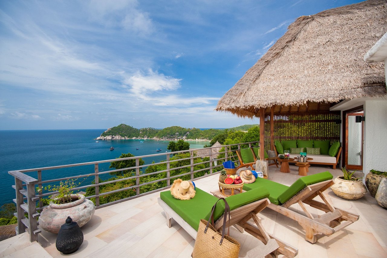 Villa terrace at Cape Shark Pool Villas under a thatched roof overlooking Shark Bay