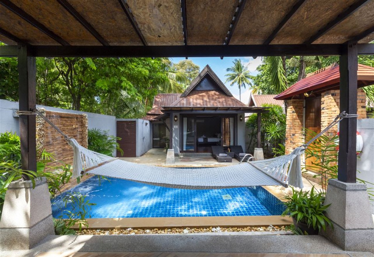 Private pool villa with a hammock over the plunge pool in tropical gardens