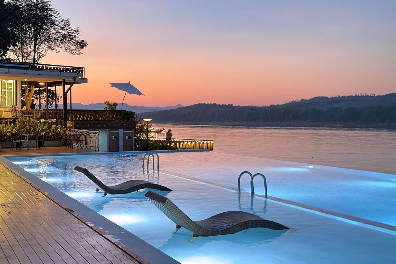 Infinity pool at sunset over the Mekong River at Chiangkhan River Mountain Resort