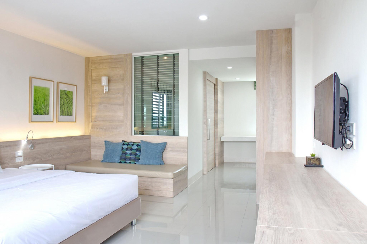 ห้องพัก Pannara Hotel ลพบุรี โทนขาว-ไม้อ่อน เตียงปูผ้าขาว ทีวีติดผนัง
