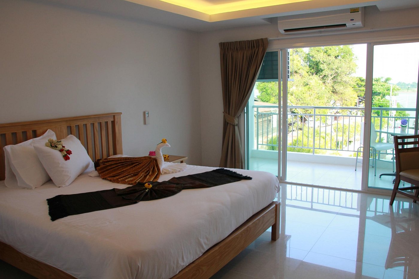 ห้อง Deluxe เฟอร์นิเจอร์ไม้จริง เตียงใหญ่ มีระเบียงและประตูกระจกบานเลื่อน