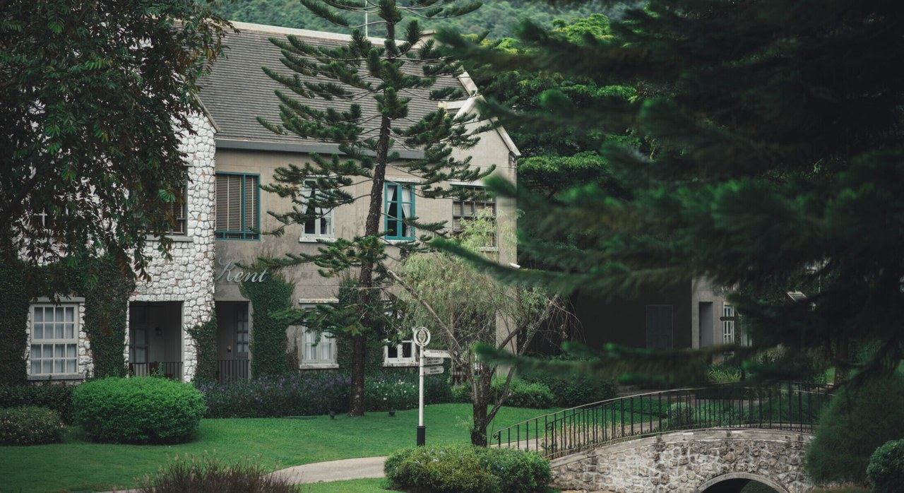 English-style stone buildings and a stone bridge over the stream at Thames Valley Khao Yai