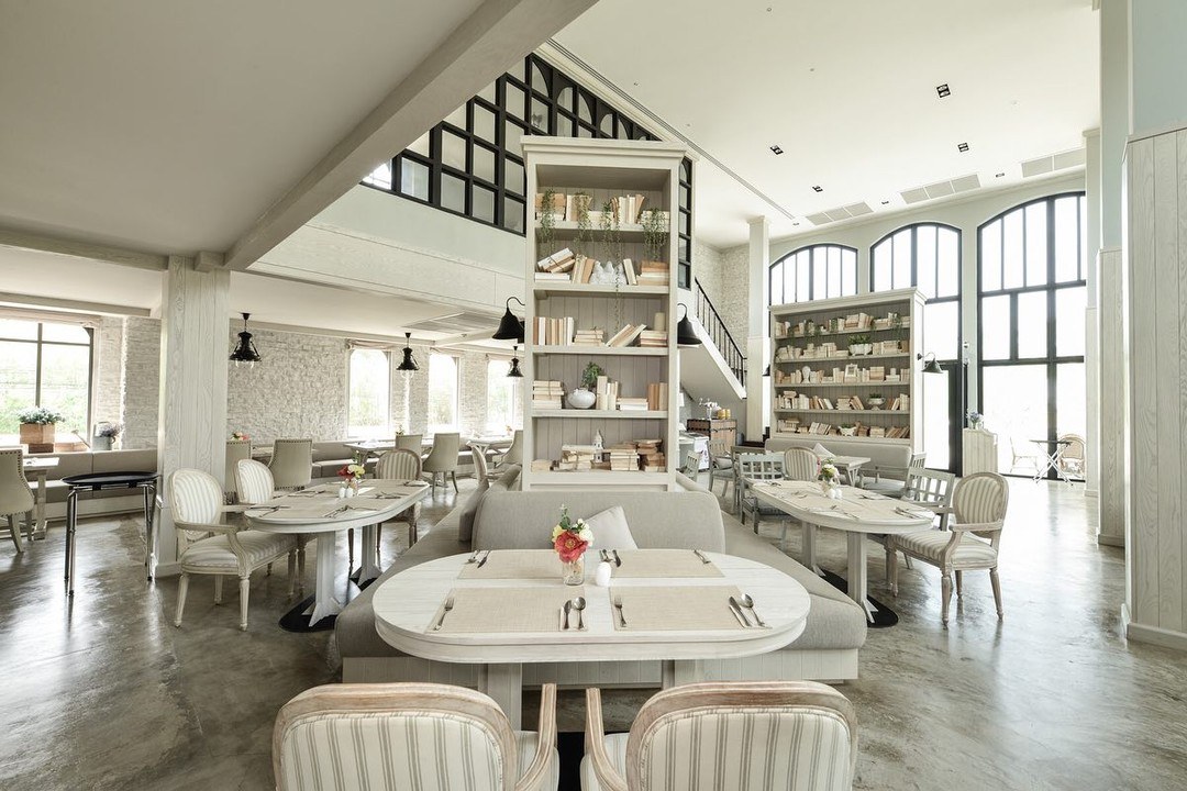 Inside The Castle Restaurant — high ceilings, stone walls, floor-to-ceiling bookshelves