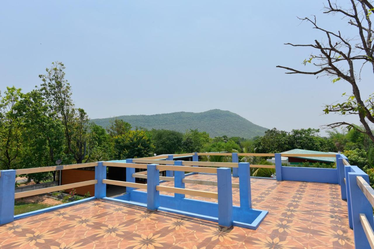ดาดฟ้าปูกระเบื้องของ Chomduen Phu Kao Resort มองเห็นแนวภูเก้าเป็นฉากหลัง