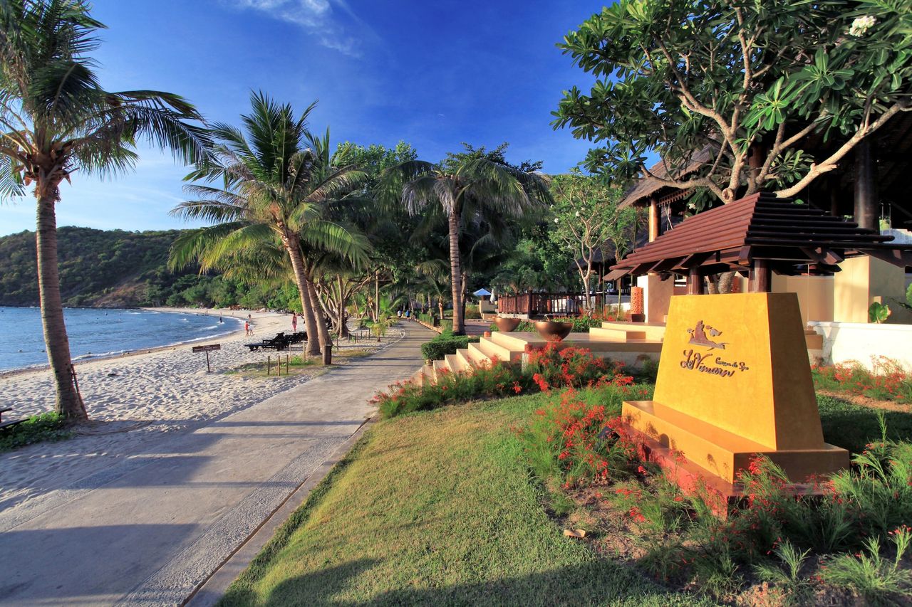 ทางเดินริมหาดอ่าวพร้าวพร้อมป้ายรีสอร์ท Le Vimarn