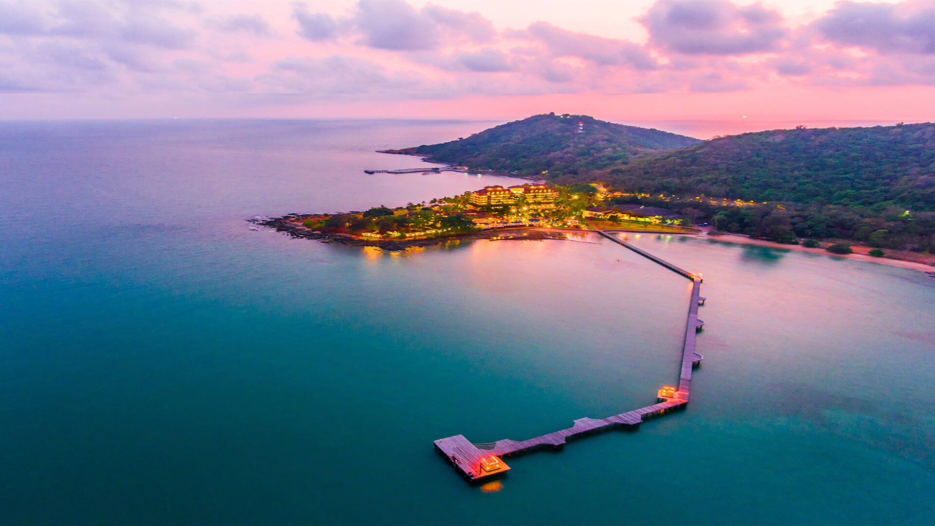 Aerial sunset view of the private pier reaching into the sea at Rayong Resort Hotel
