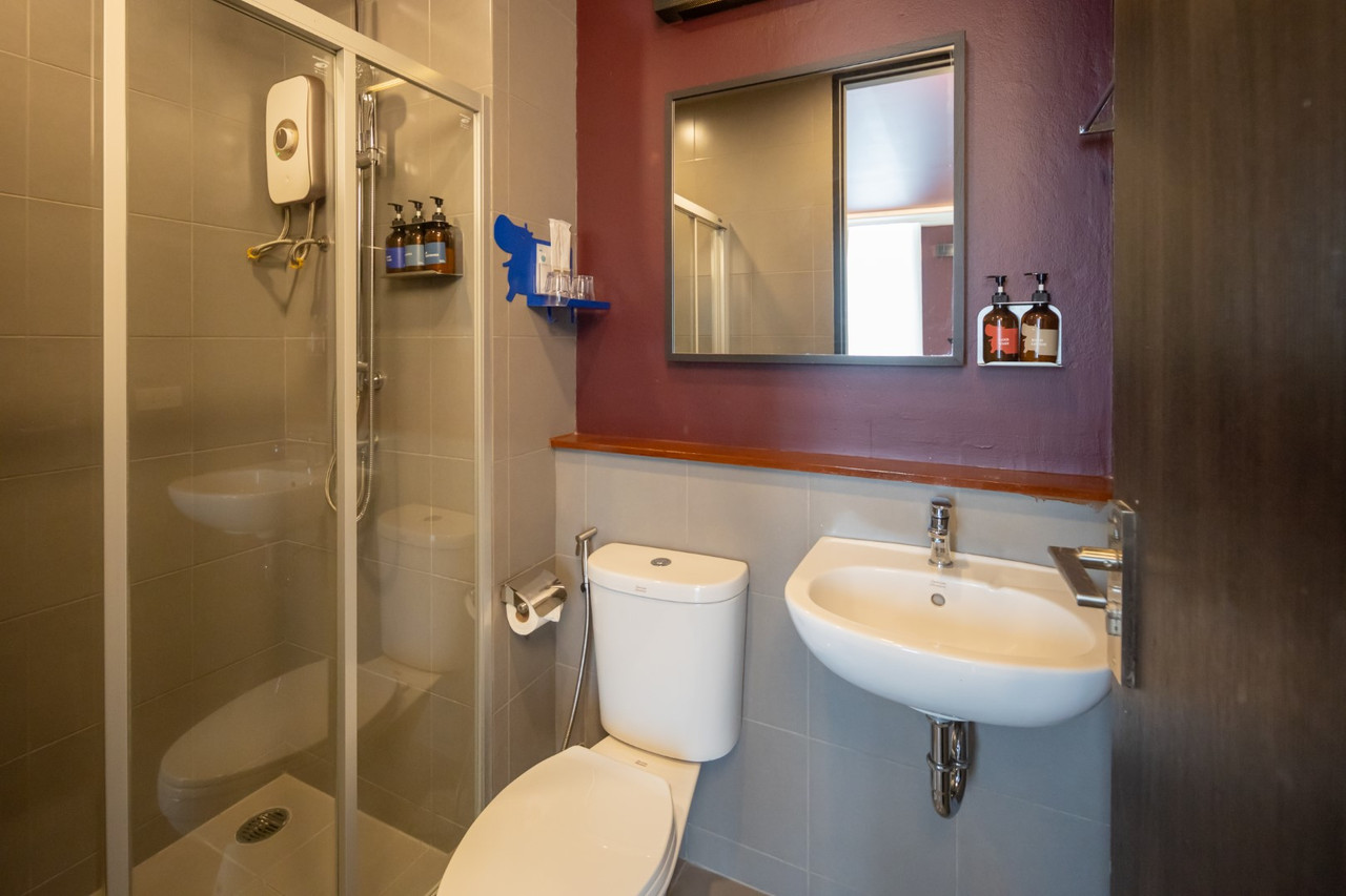 Bathroom with a blue hippo-shaped amenity shelf and a glass shower