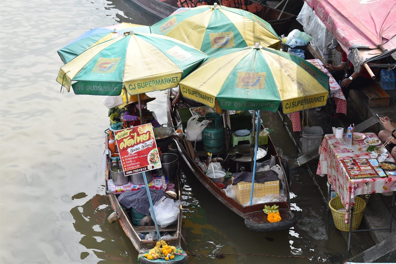 Rowboat food vendors in the Amphawa Floating Market seen from a room balcony