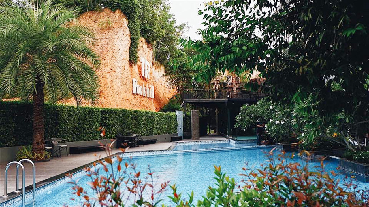 Outdoor pool set against the rock cliff at TR Rock Hill Hotel Hat Yai