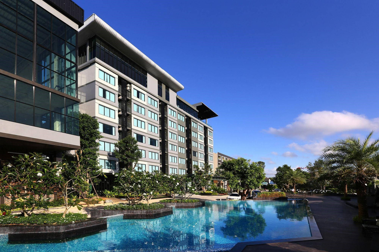 Hotel building and outdoor pool during the day