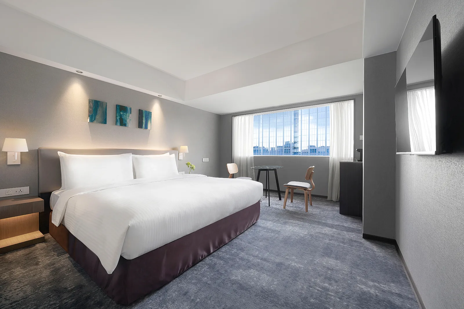 Renovated Deluxe King room at ILLUME Taipei — grey tones, king bed, city view